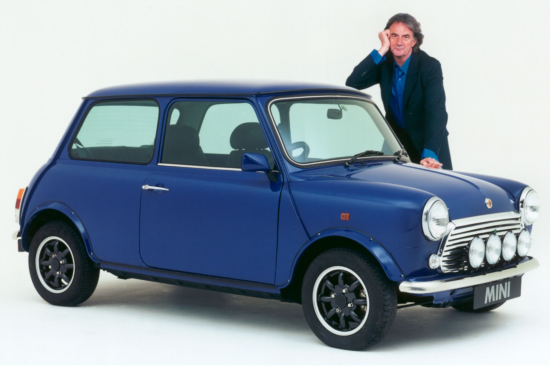 A limited edition MINI featuring a custom blue color scheme applied to the body and wheels, posing with Paul Smith